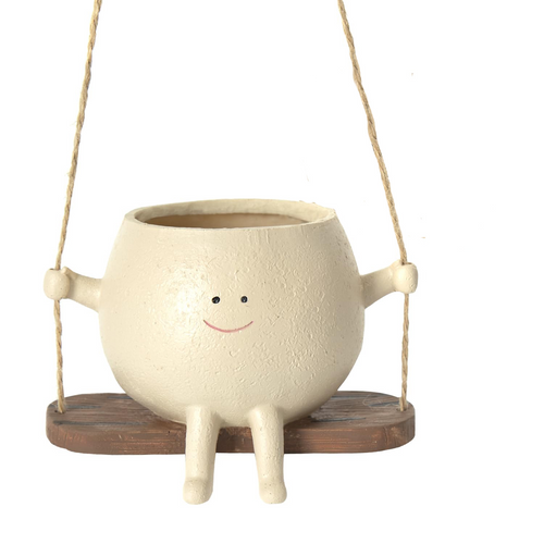 Miniko Swing Time smiley face hanging planter on a wooden swing, front view on white background